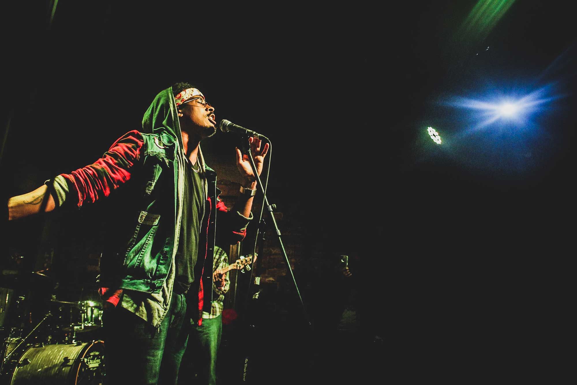 Vocalist performing with a live band on stage at Apache XLR in Downtown Atlanta