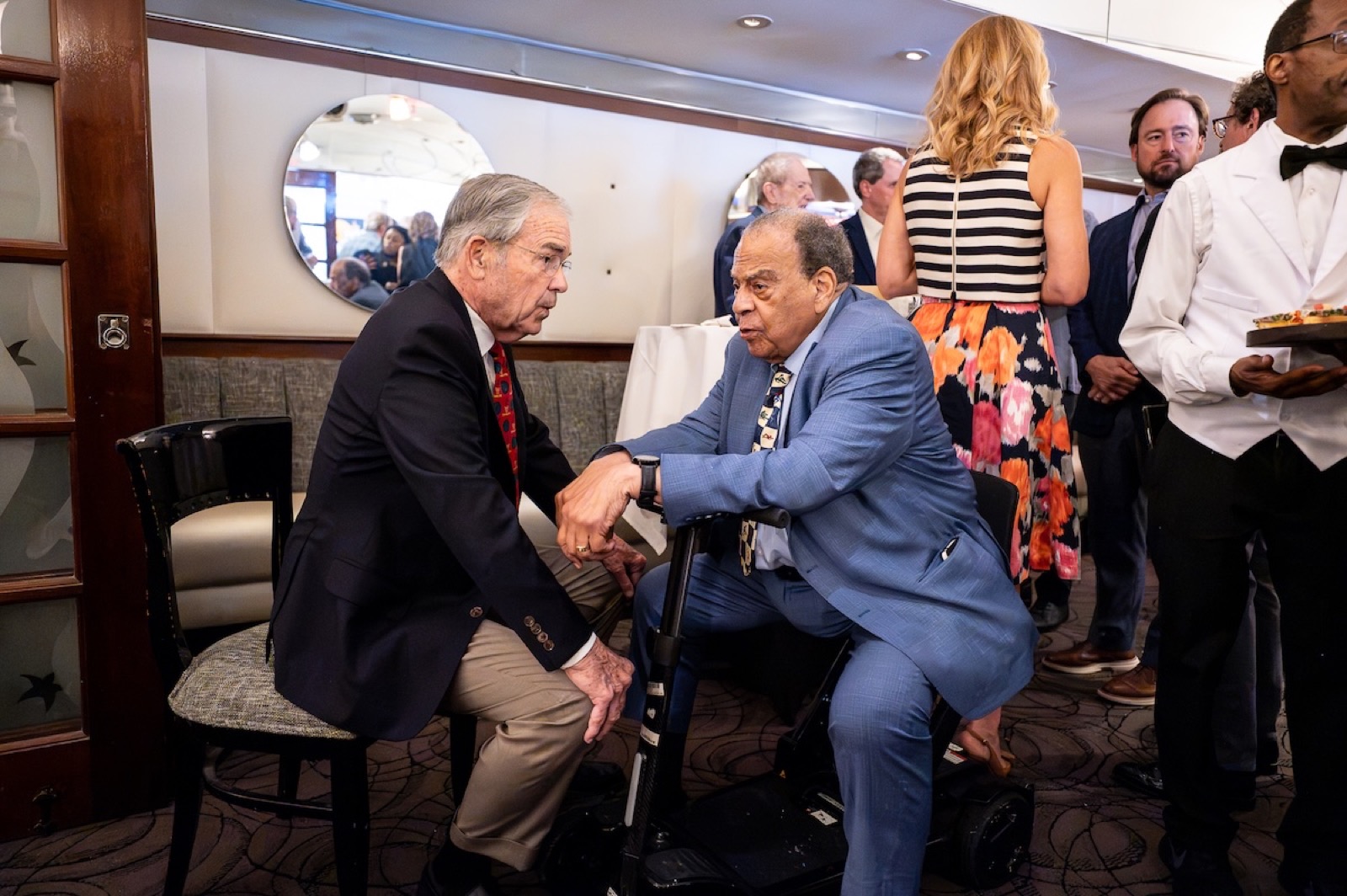 Billy Payne speaks with Andrew Young at a dinner marking 30 years since the 1996 Atlanta Olympics