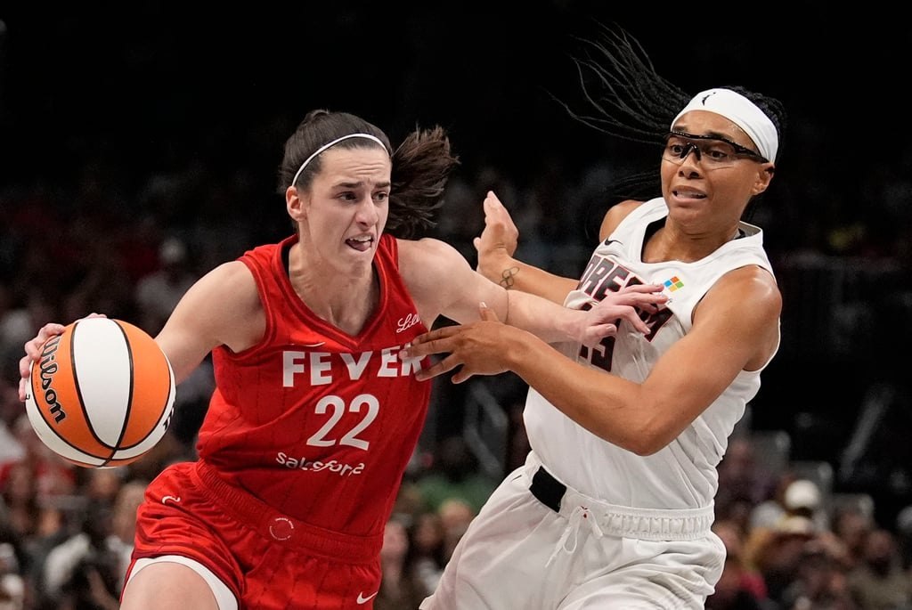 Indiana Fever guard Caitlin Clark drives past Atlanta Dream guard Allisha Gray during the August 26, 2024 game at State Farm Arena