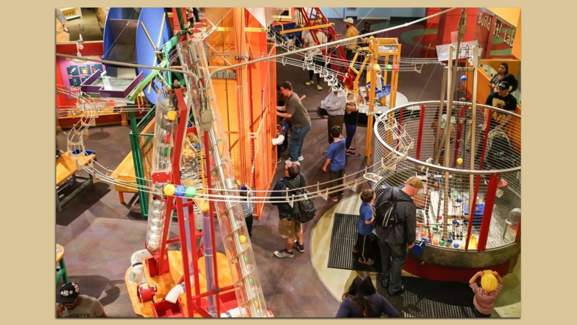 The Ball Machine exhibit at the Children's Museum of Atlanta, a tall contraption of tubes and chutes carrying colored balls.