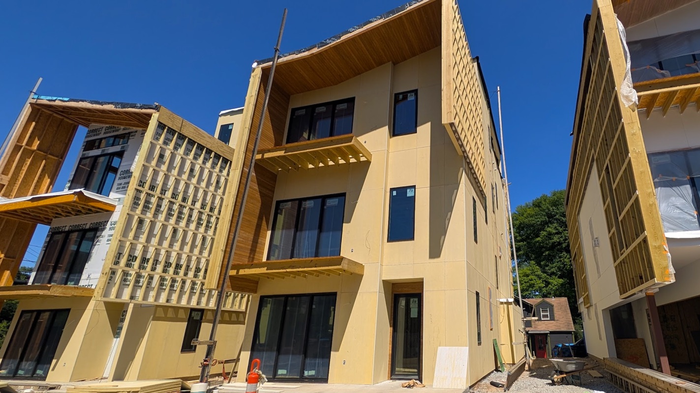 Three modern four-story homes under construction at Fortune Street and Ralph McGill Boulevard
