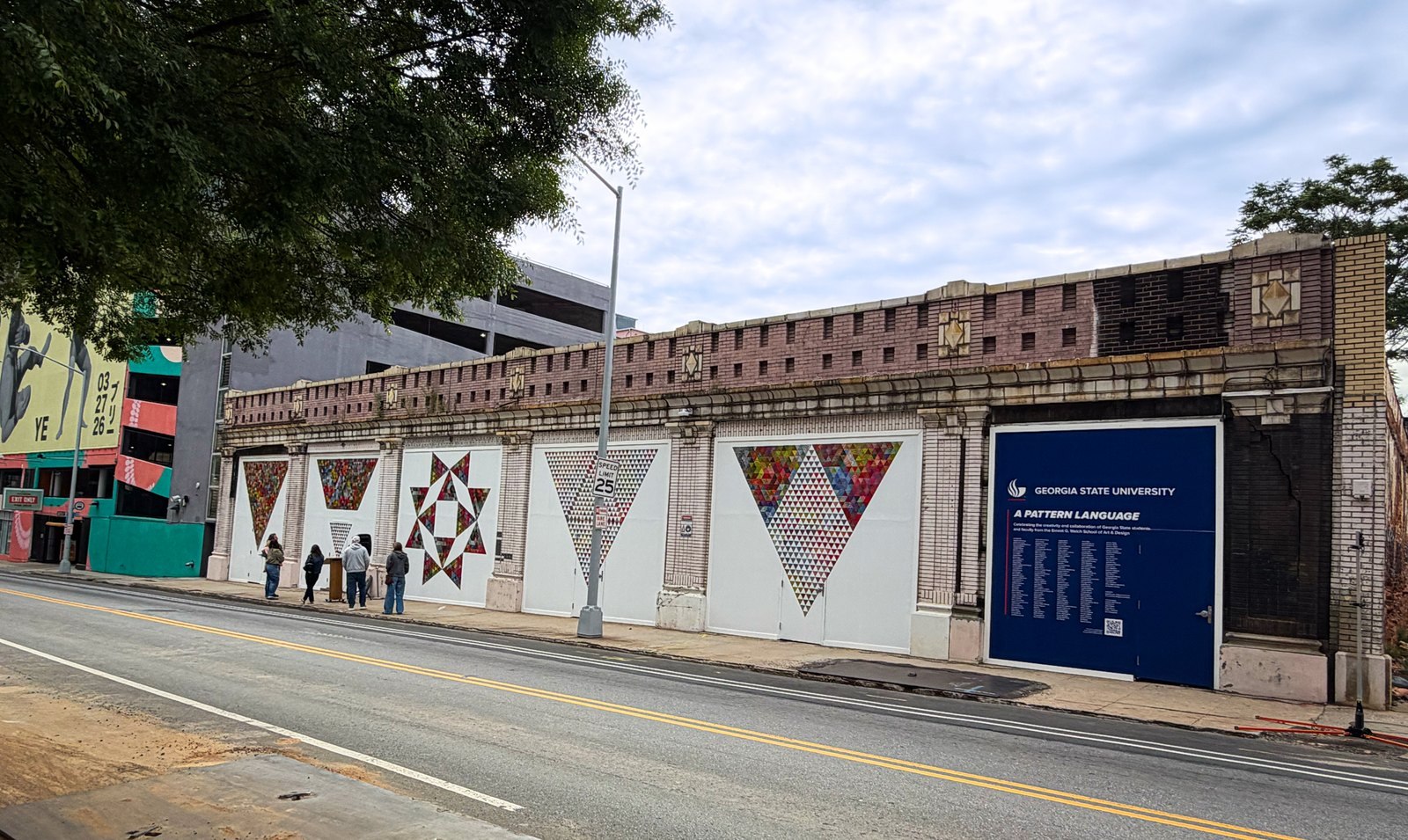 Georgia State students' geometric triangle-pattern mural panels and an "A Pattern Language" sign along a historic brick building on Forsyth Street in South Downtown Atlanta