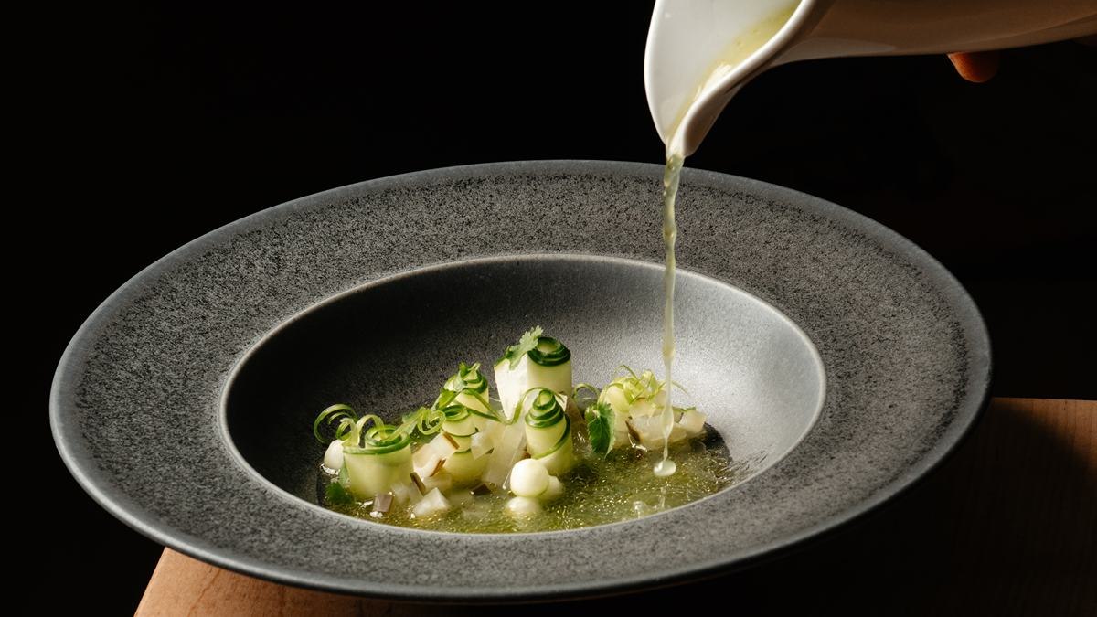 A server pours broth over Carmen's Cucumbers, a dish on the menu at Heritage in Summerhill