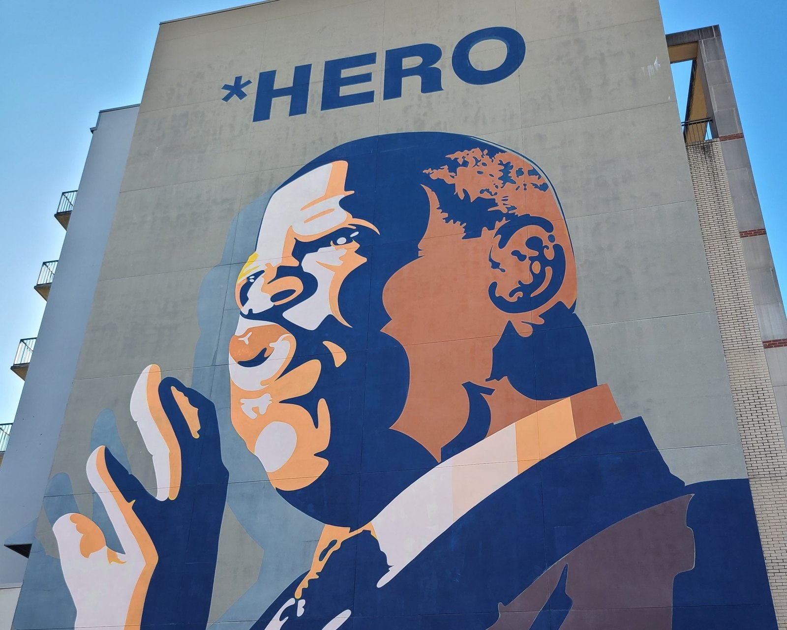 The six-story John Lewis HERO mural, showing Lewis mid-speech beneath the word HERO, painted on the side of 171 Auburn Avenue in Sweet Auburn