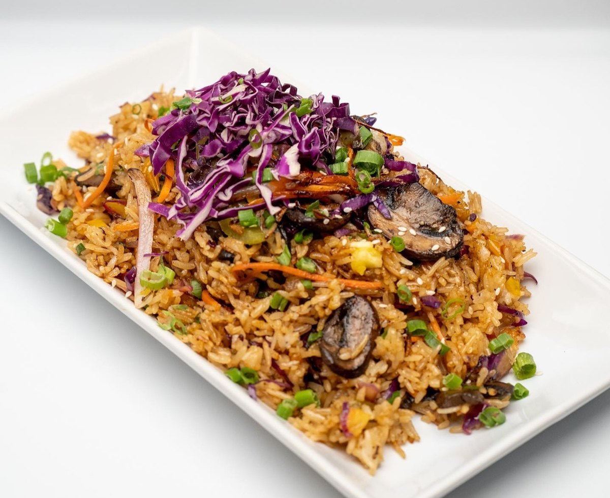 Plate of MattChews vegetable fried rice with mushrooms, carrots, green onions and shredded red cabbage