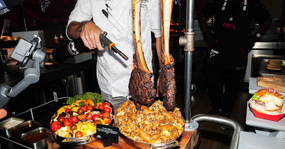 Senior executive chef Matt Cooper torches a steak at a Mercedes-Benz Stadium food showcase, Sept. 15, 2026