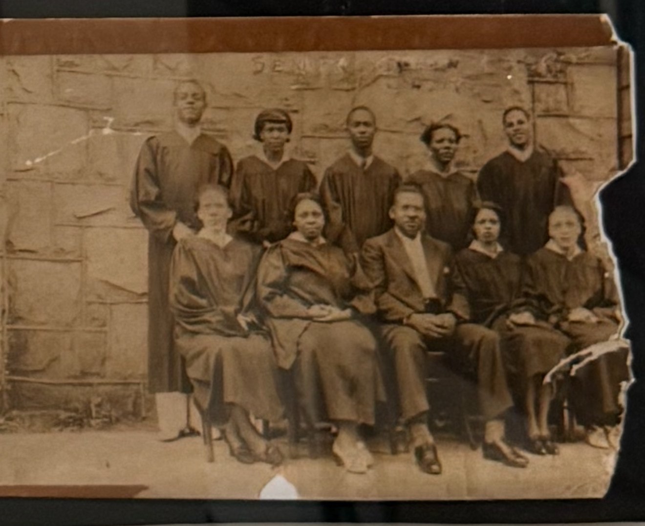 Sepia 1942 photograph of the Reed Street Baptist Church choir in robes, with pastor Clifford Nathaniel Ellis seated at center