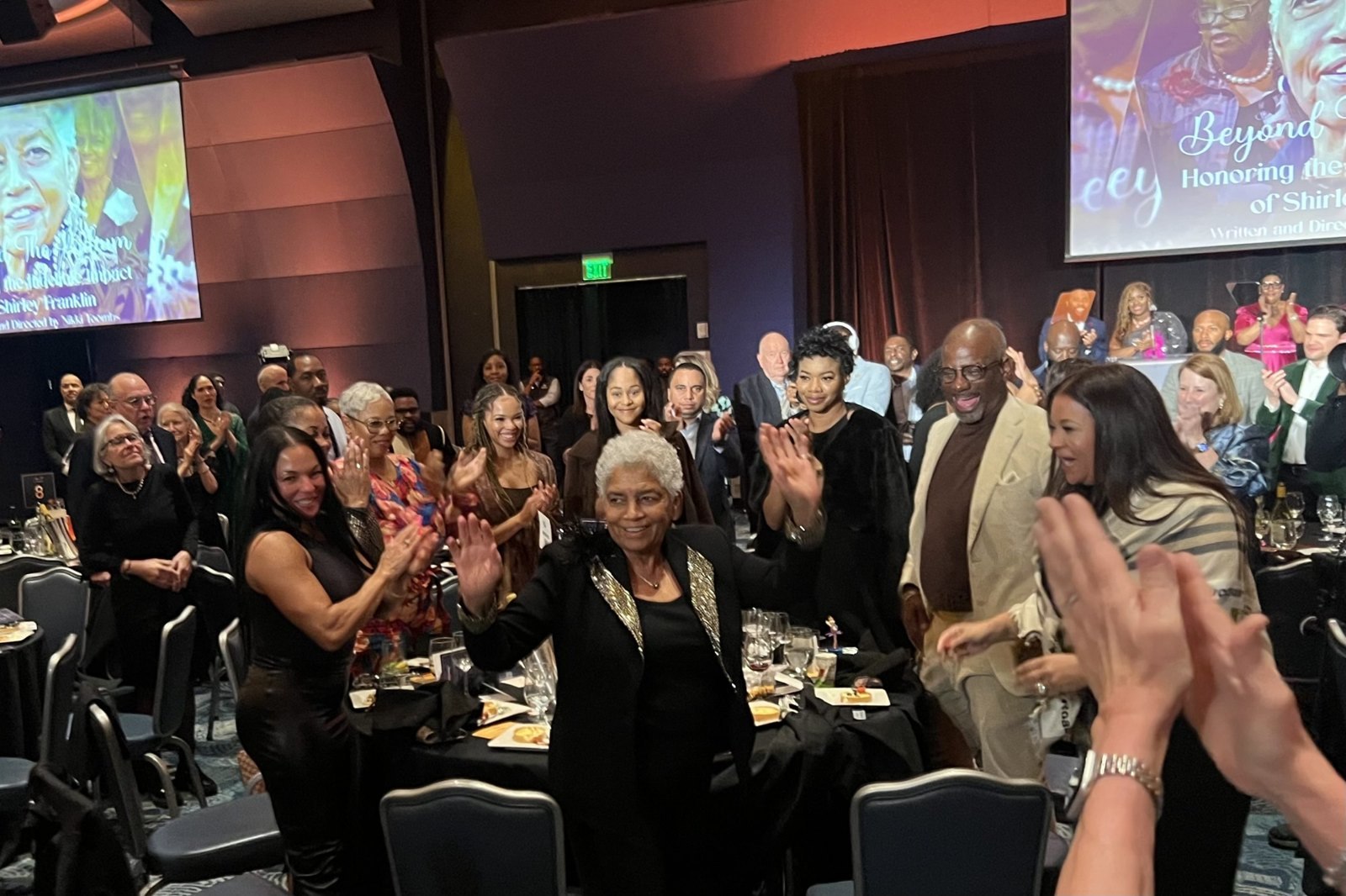 Former Atlanta Mayor Shirley Franklin waves to a standing, applauding crowd at the 2025 Power to Inspire gala for the National Center for Civil and Human Rights