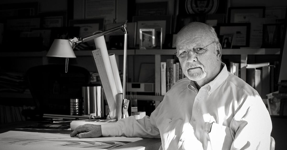 Architect Tom Ventulett III seated at his drafting desk
