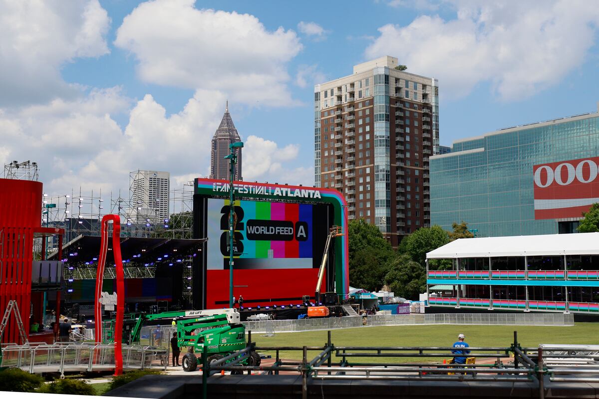 Workers prepare the main stage at the FIFA Fan Festival at Centennial Olympic Park