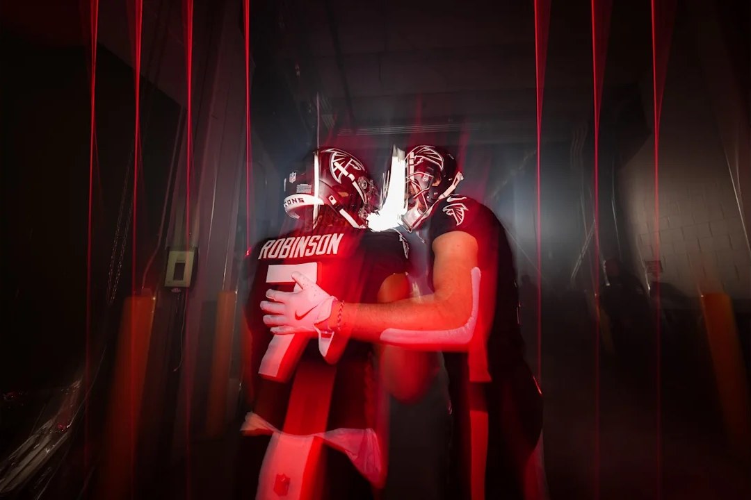 Atlanta Falcons wide receiver Drake London and running back Bijan Robinson walk out onto the field at Mercedes-Benz Stadium before a game against the Carolina Panthers.