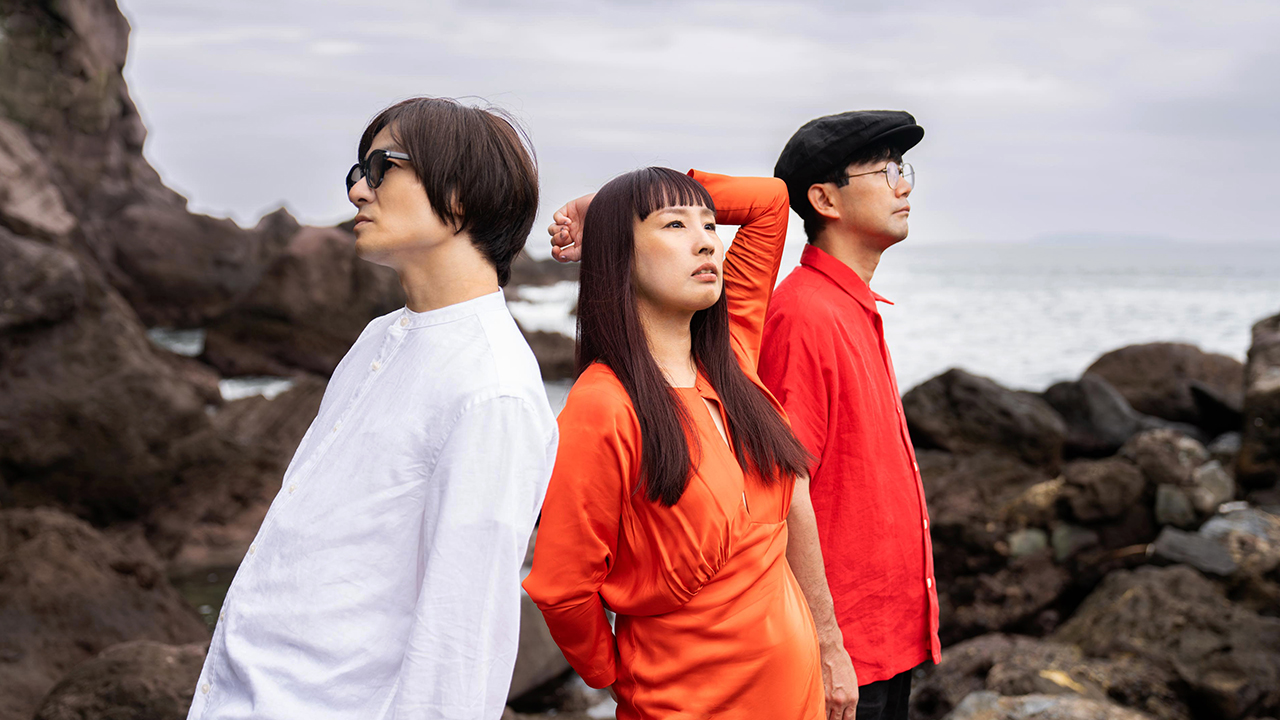 Japanese indie rock trio Mass Of The Fermenting Dregs pictured with their instruments.