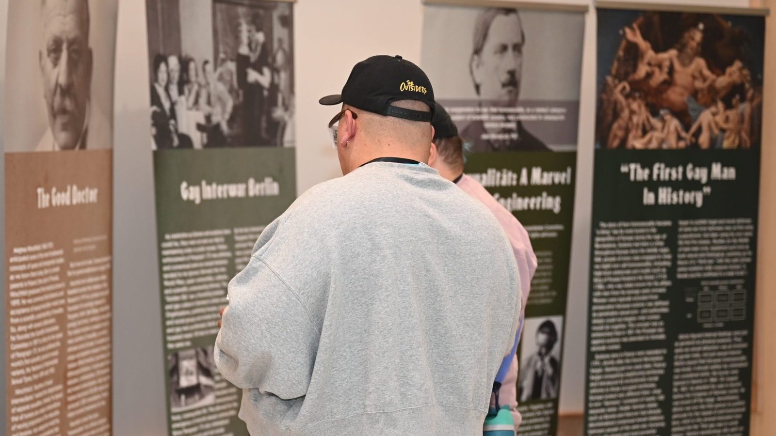 A visitor reads LGBTQIA+ history exhibition panels at the National Center for Civil and Human Rights