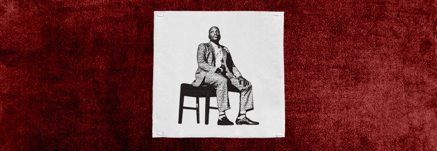 Ali Siddiq: The Custom Fit Tour key art — the comedian seated on a stool in a suit, rendered as a black-and-white halftone print on a white patch over a deep red textured background.